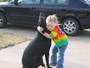 A little girl hugging her dog.